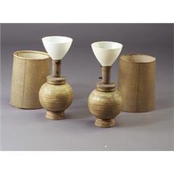 Pair of JAMES MONT spherical footed lamp bases with gold accents and incised horizontal banding....