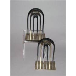WALTER VON NESSEN for CHASE Art Deco bookends with concentric arches in two-tone patinated metal....
