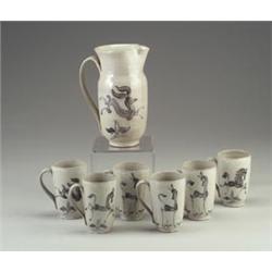 Seven-piece SCHEIER redware pitcher and mug set, each decorated with assorted quadrupeds in black...