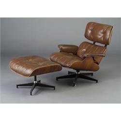 CHARLES EAMES for HERMAN MILLER walnut veneer lounge chair and ottoman with tufted brown leather...