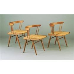 Three GEORGE NAKASHIMA grass-seated side chairs with rounded back and three pair of spindled supp...