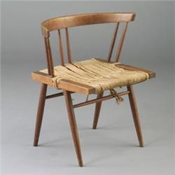 GEORGE NAKASHIMA walnut grass-seated dining chair. Minor fraying to seat. Unmarked. 26 1/2" x 24"...