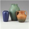 Image 1 : Three ceramic matte-glazed vessels: a tapering vase in dark blue, an urn in speckled brown, and a...