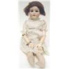 Image 1 : A Schoenau & Hoffmeister 1909 bisque head doll with jointed composition body, partially clothed,...