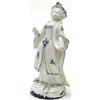 Image 1 : An 18th century French (?) hard paste figure of a lady in blue tinted flowing gowns, a floral enc...