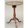 Image 1 : A George III mahogany tea table with dished circular top, birdcage and baluster stem and cabriole...