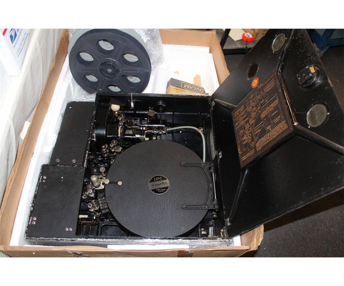 IPC SIMPLEX 35MM MOVIE PROJECTOR WITH 3 BOXES OF 35MM FILMS