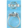 Image 1 : An Art Deco gold ring claw-set with a cushion cut aquamarine, each shoulder set with a brilliant...