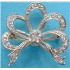 Image 1 : A gold 5 loop tied ribbon brooch set rose cut diamonds, the centre with a replacement white paste...