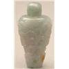 Image 1 : A mottled celadon and brown jade triangular c...