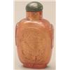 Image 1 : An amber rounded rectangular bottle carved wi...