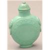 Image 1 : A turquoise matrix bottle of disc shape, anim...