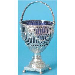A George III pierced and chased silver sugar vase with swing handle and beaded borders, the sides...