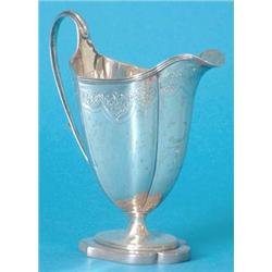 A George III silver cream jug of faceted vase form with reeded rim, the shaped sides with bright...
