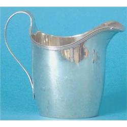 A George III silver oval section helmet shaped milk jug with reeded rim and handle, Maker John Br...