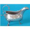 Image 1 : A George III silver sauceboat with crimped rim and leaf capped upscrolled handle on 3 scroll legs...