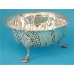 An 18th century Irish silver bowl with shaped rim and chased wrythen fluting, engraved with two c...