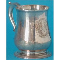 A George III silver baluster mug with double scroll handle, engraved with a contemporary coat of...