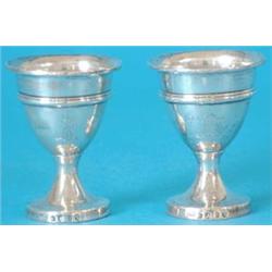 A pair of George III silver vase shaped egg cups, each engraved with an axe crest, Makers R & D H...