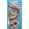 Image 1 : A gilt metal openwork hinged bangle, the scroll motifs with blue enamel and seed pearl decoration...