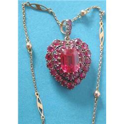 An early 20th century gold and silver heart shaped pendant set synthetic rubies, the central rect...