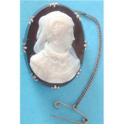 A 19th century hardstone cameo brooch carved with a study of a female profile to right wearing Tu...