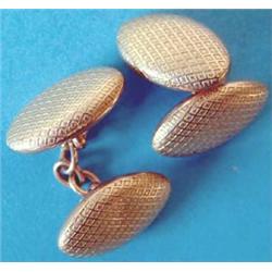 A pair of 9ct hollow gold oval cufflinks with chequer engraving and chain link connections Estima...