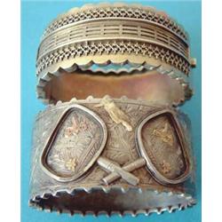 A Victorian white metal hinged bangle, the front with applied and engraved decoration of butterfl...