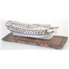 Image 1 : A French Prisoner of War bone model of a ship's hull, circa 1800, on fruitwood rectangular stand...