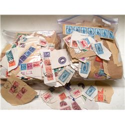 Two bags of cut stamps - many with multiple stamps