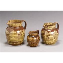 Three Staffordshire Yellow Transfer Printed Glazed Brownware Graduated Jugs...