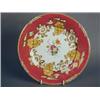 Image 1 : A Rockingham porcelain plate, decorated to the centre with a floral spray within a claret ground...