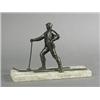 Image 1 : A 20th century German bronzed figure of a skier, on a rough cut stone plinth base, printed retail...