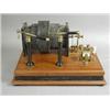 Image 1 : A 19th century electrical coil on a mahogany stand, 38cm long Est. 250/300...