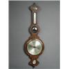 Image 1 : A George III rosewood wheel barometer, with a small convex mirror Est. 200/300...