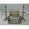 Image 1 : A cast iron fire grate and spit dogs with log guard and spit baton (?), 52 x 34cm Est. 100/150...