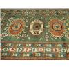 Image 1 : A Chechen green ground handmade woollen rug, 2.05 x 1.82m Est. 300/350...