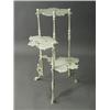 Image 1 : A cast iron plant stand with three butterfly shaped shelves, 82cm high Est. 100/200...
