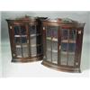 Image 1 : A pair of glazed bow front hanging corner cupboards, 20th century, each 105cm high Est. 300/500...