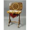 Image 1 : A Victorian walnut sewing table with a shaped top, opening to reveal a fitted interior, over deli...