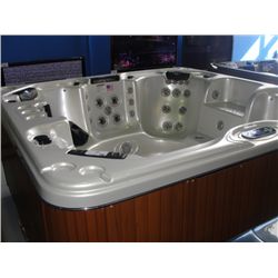 CAL SPAS ESCAPE SELECT SERIES HOT TUB WITH IVORY INTERIOR AND TEAK CABINET. FEATURES INC: