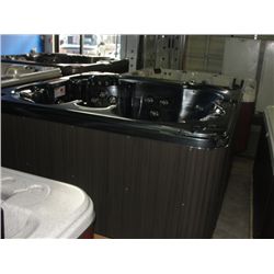 CAL SPAS CONNECT SERIES HOT TUB WITH MIDNIGHT OPA INTERIOR AND WALNUT CABINET. FEATURES INC: