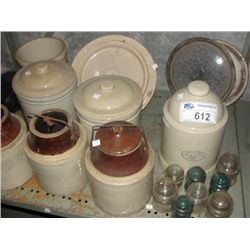 SHELF LOT OF ASSORTED VINTAGE STONEWARE CROCKS AND VINTAGE BRASS PHONELINE INSULATORS