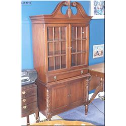 Vintage mahogany display/storage cabinet with twist columns, lion's head motif pulls and finial