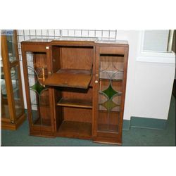 A Deco style drop front cabinet with double glazed and leaded glass doors