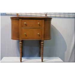 A Canadian made oval shaped floor standing sewing box with flip top wool storage, rotating spool hol