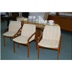 A Danish made dining table with two large leaves marked Dyrlund Denmark and four upholstered teak di