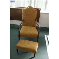 A vintage upholstered armchair with barley twist supports and matching ottoman