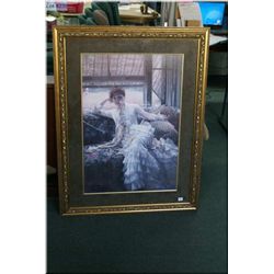 A large gilt framed print of a young lady in recline