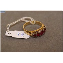 Lady's 14kt yellow gold and channel set ruby ring. Set with 1.00 ct of oval cut natural rubies. Reta